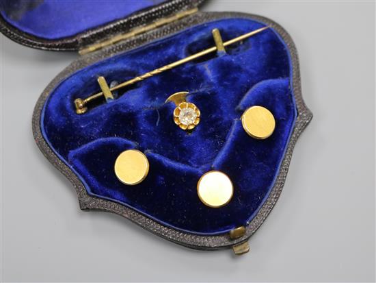 Three 18ct gold dress studs, a stick pin and an 18ct gold and diamond set dress stud.